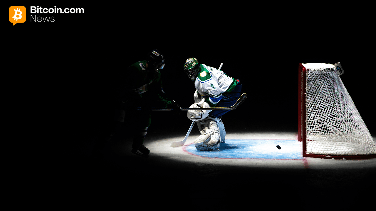 Hockey player facing a goalie in the spotlight