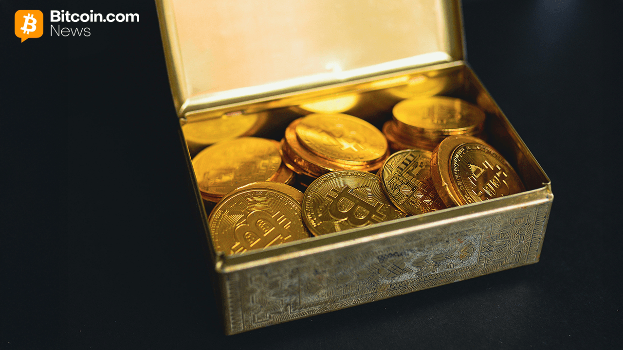 Old bitcoin in a treasure chest with a black backdrop.