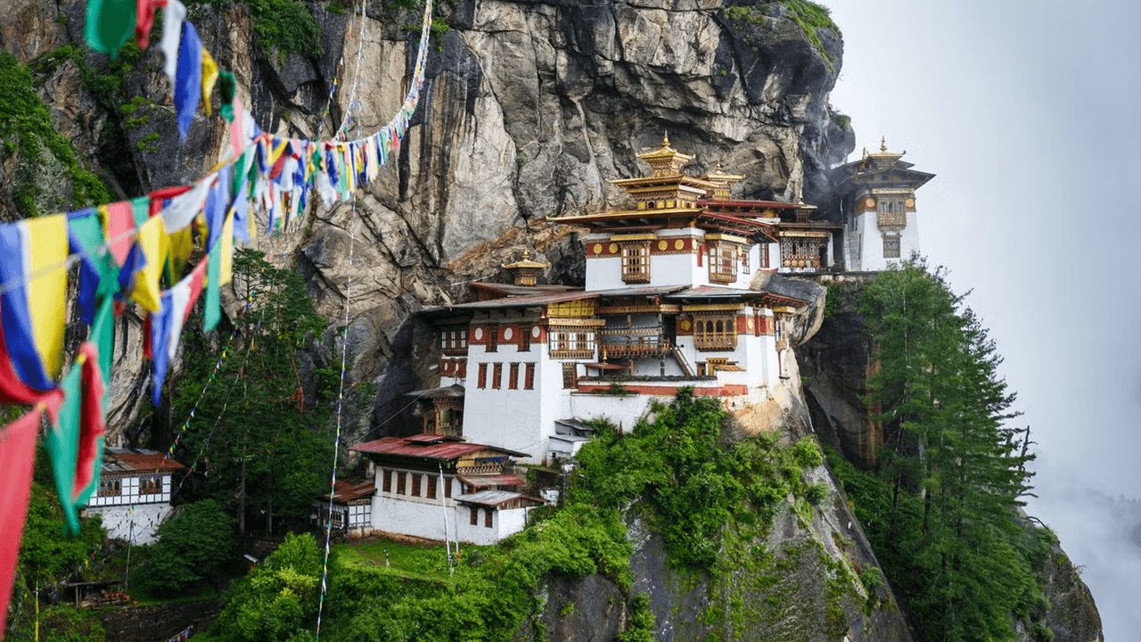 Photo of a Bhutanese monastery amidst a nature focused backdrop.
