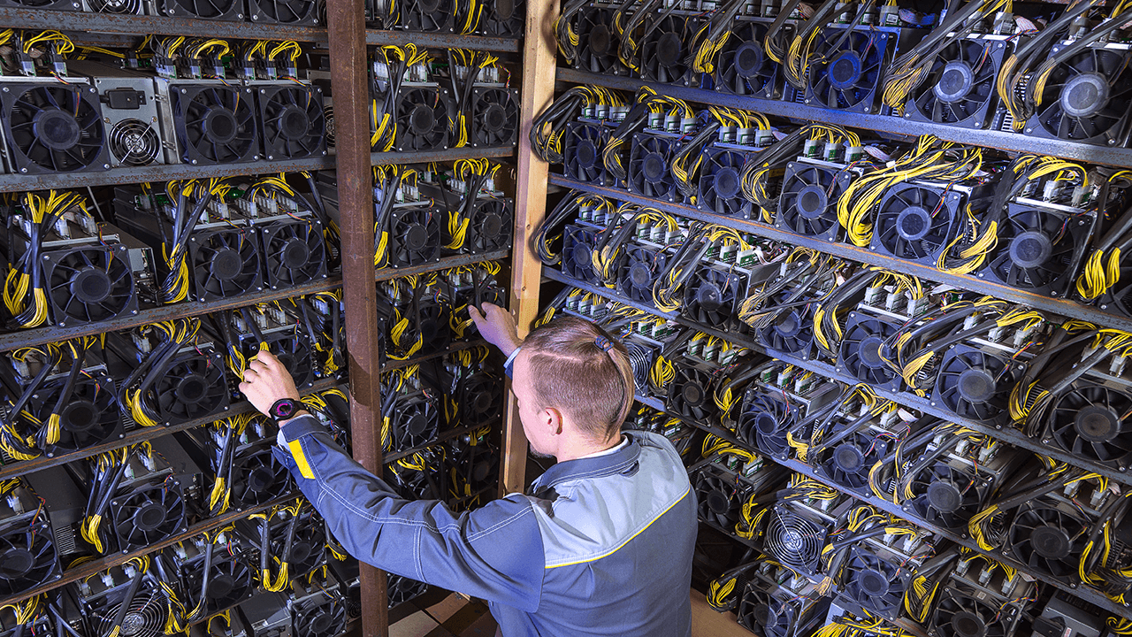 Man working at a bitcoin mining facility.