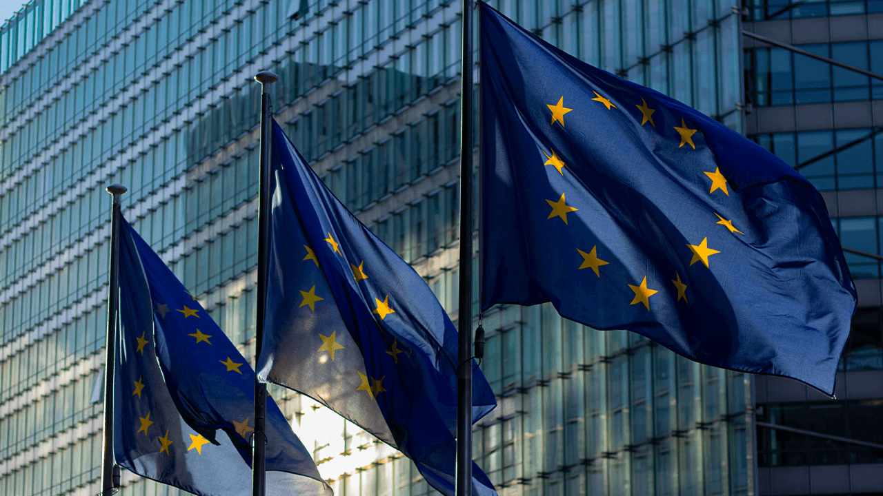 European flags waving in the city on a sunny day.