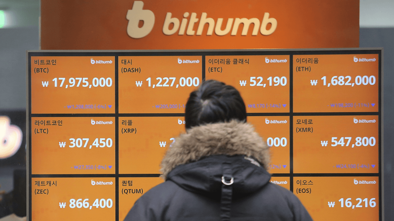 Man in South Korea looking at a Bithumb sign.