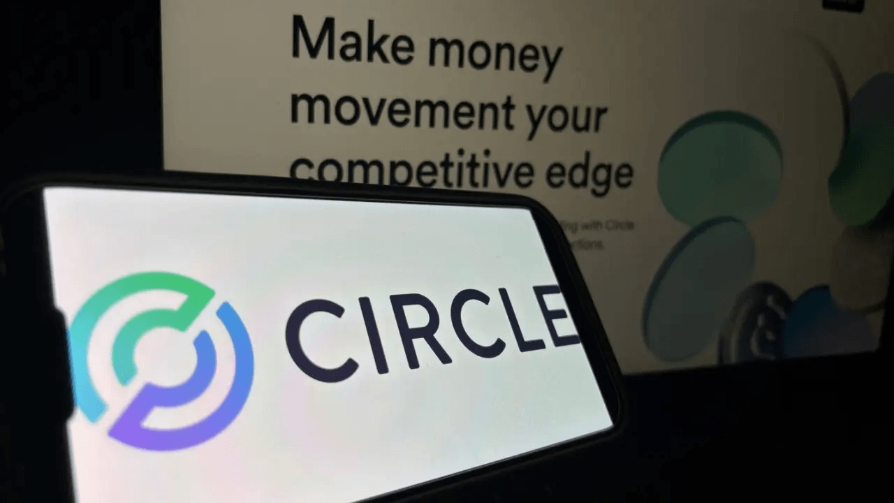 Circle logo on a smartphone next to a desktop.