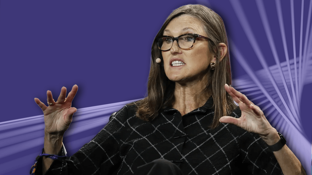 Ark Invest’s Cathie Wood speaking on stage at an event.