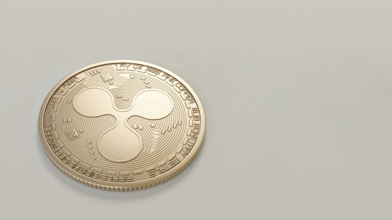 A coin with the Ripple/XRP logo on it.
