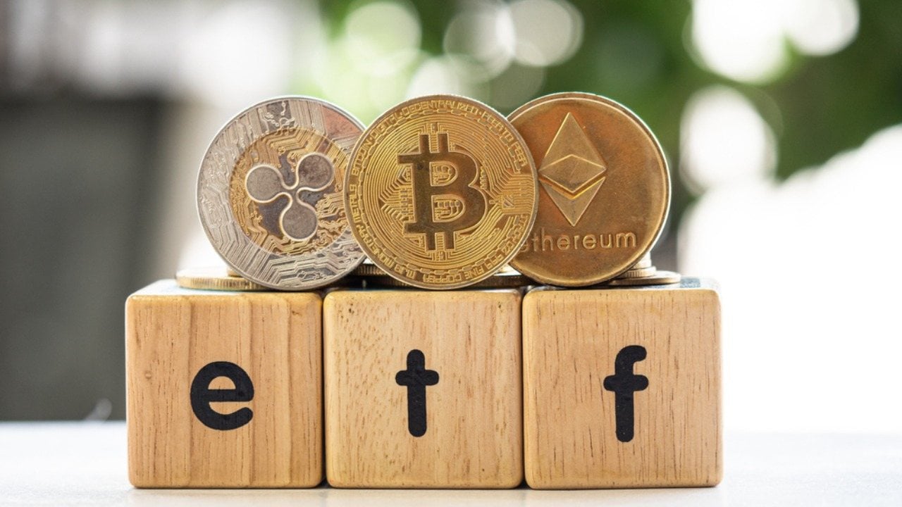 Bitcoin, Ether, XRP on wooden box with ETF