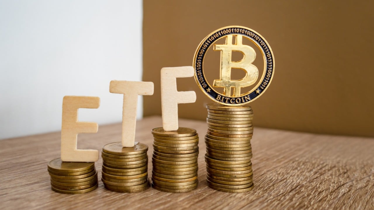 Bitcoin coin with ETF text put on piles of coins arranged from low to high