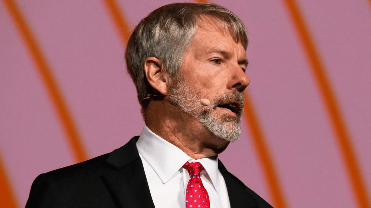 Saylor speaking on stage at a conference