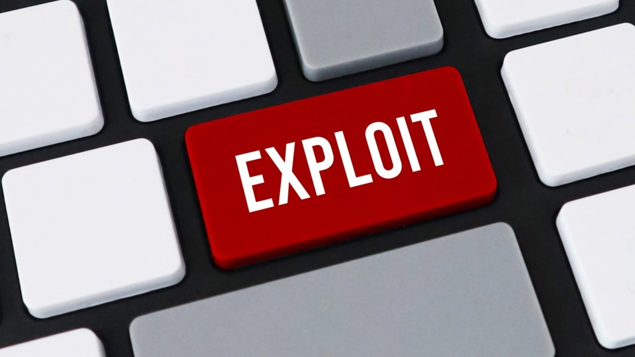 computer keyboard with red key featuring the white text EXPLOIT