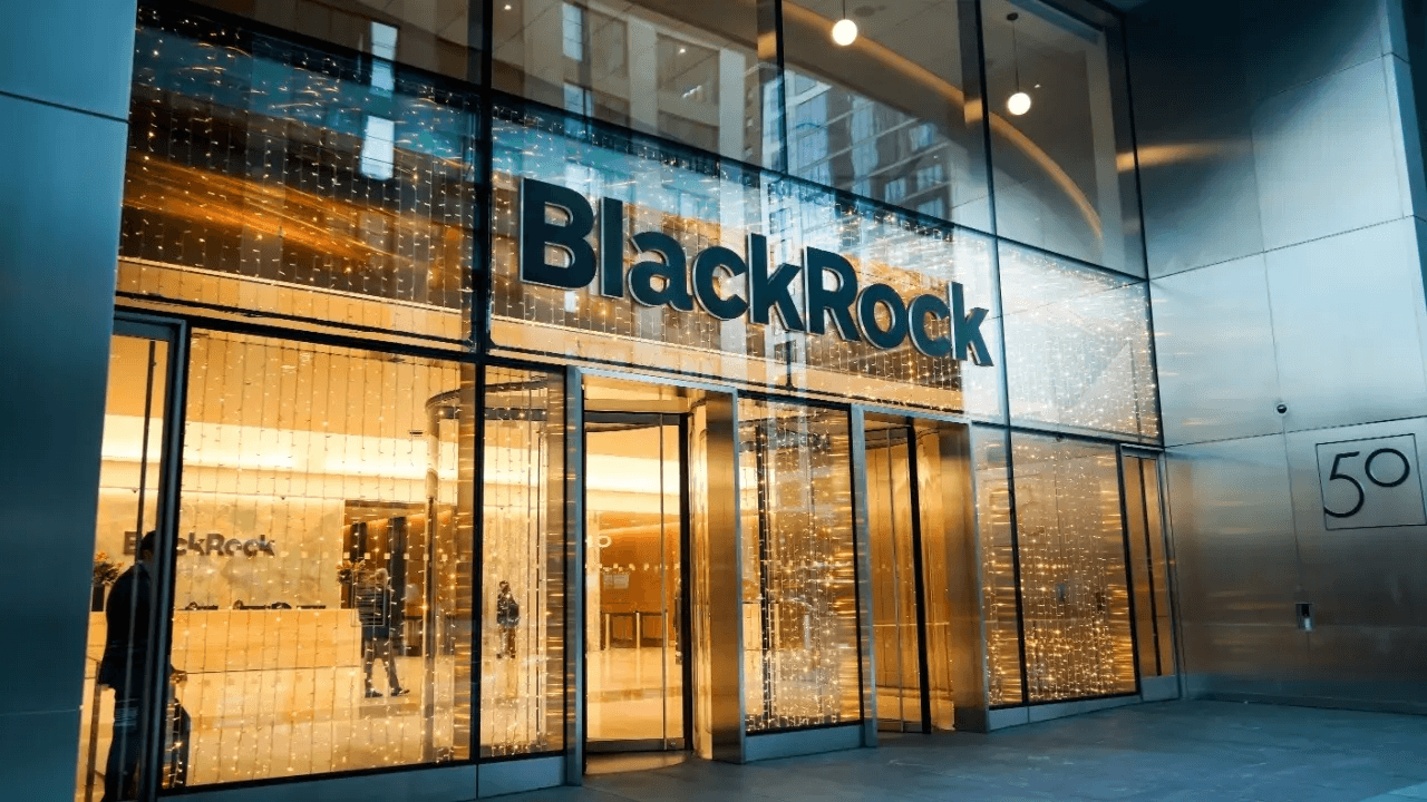 Illuminated glass entrance of a Blackrock office building at dusk