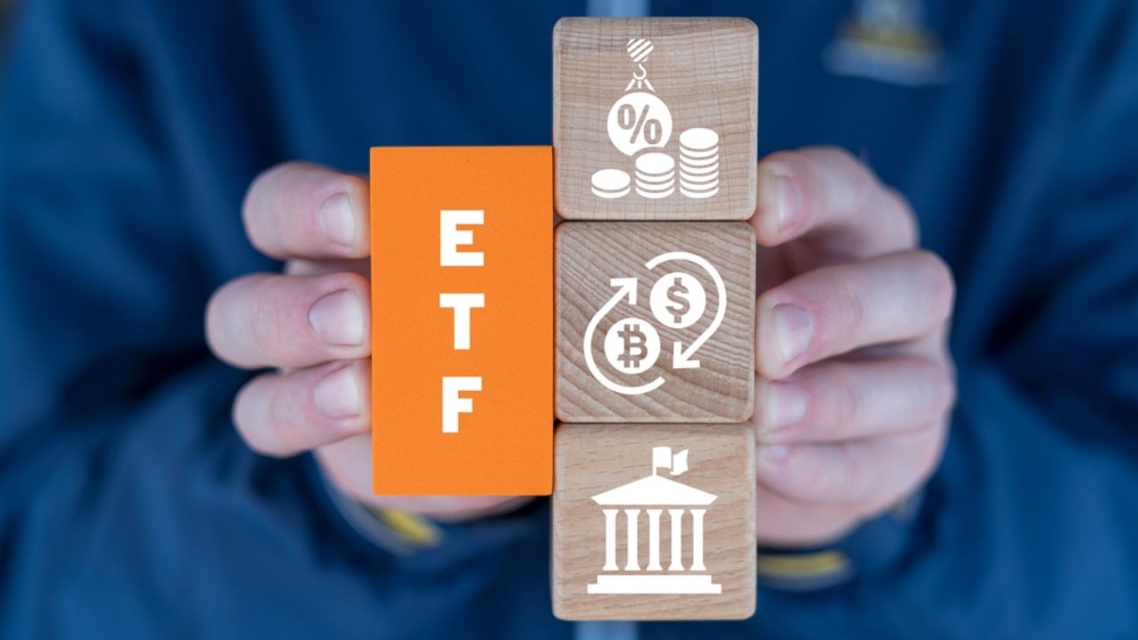 Man holding colorful blocks with text ETF