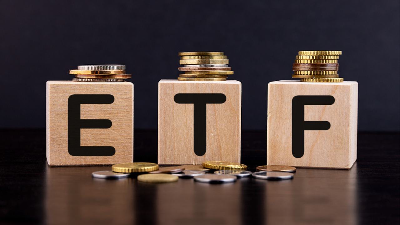 ETF on wooden blocks with coins stacked
