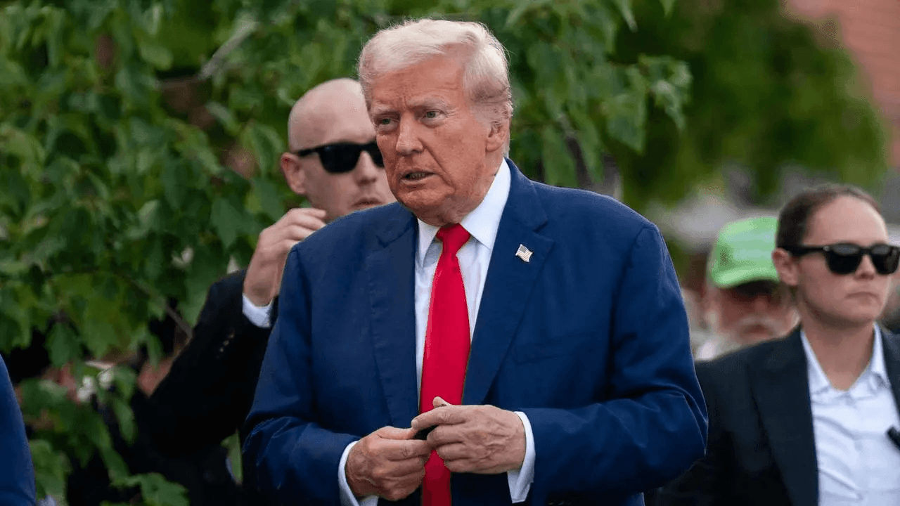 Donald Trump walking with Secret Service agents.
